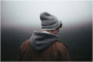 شاي يرتدي قبعة الشتاء وينظر للأسفل