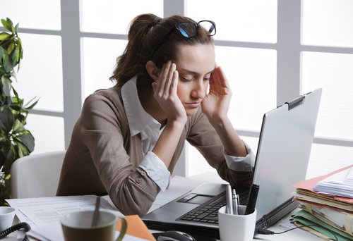فتاة تعامي من صداع أثناء العمل