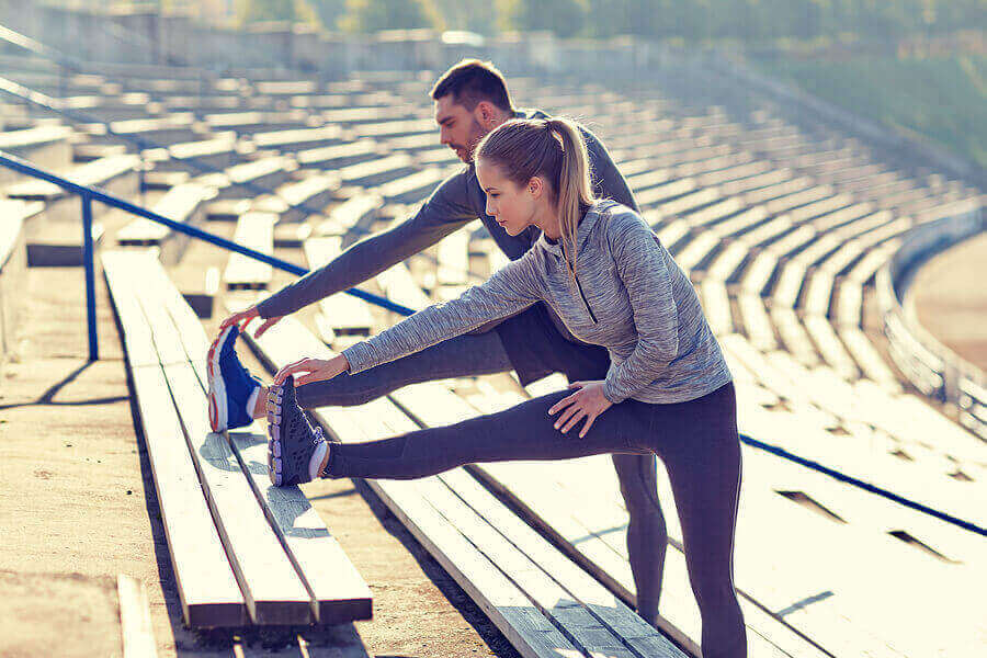 زوجان يمارسان تمارين الإطالة والتمدد قبل ممارسة رياضة الجري
